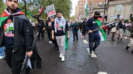 Pro-Palestinian protesters drumming in central London with flags and placards against Israeli strikes on Gaza