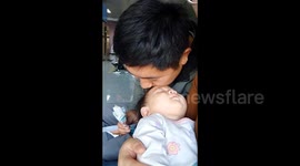 Father uses ice lolly in mouth to physically cool down feverish daughter in China