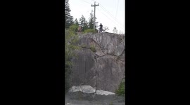 Mountain Biker Rides Vertical Rock Wall