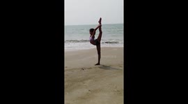 Eleonora, a young aspiring gymnast from Surgut, Russia practices her sports on Cavelossim beach while on a holiday in the Indian state of Goa