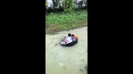 Dog tries to climb into children's floating tub in canal