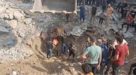 Excavator used to dig through rubble of destroyed buildings in Gaza's Al-Shati Camp