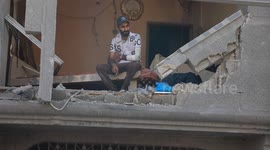 Emergency workers dig through rubble of destroyed buildings in Gaza's Al-Shati Camp