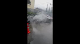 Over-heating motorcycle catches fire while parked in the rain