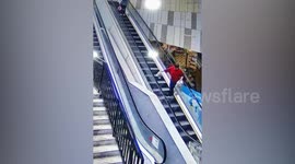 Security guard catches woman tumbling down escalator in China
