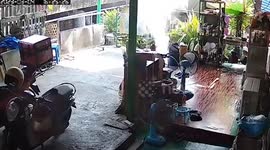 Woman extinguishes fire as wok bursts into flames in garden