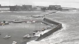 Waves lash Stonehaven Harbour in Aberdeenshire, UK