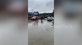 Motorist drives into man in flood water - carrying him on bonnet - before knocking over woman