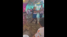 Men danced in the floodwaters that were flooding into the wedding party