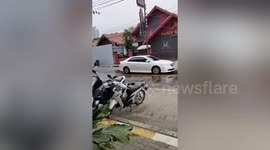 Isolated rain shower drenches only part of road in Thailand