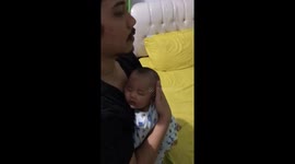 Father's tender efforts: baby's sleep interrupted by a sneezing surprise