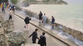 Weather UK. Surfers and thrill seekers brave a soaking on Halloween weekend Towan Beach Newquay Cornwall UK