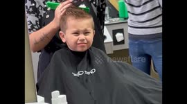 Son Practices His Best Blue Steel During Haircut