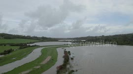 River Cuckmere (also called River Uck) bursts its banks after heavy rain submerging roads and land in its wake, Alfriston, East Sussex, UK