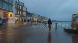 Kids swim on the streets and cars zoom through water as extreme high tide floods St Ives Harbour Front