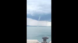 Residents watch as waterspout whirls off coastal town in the Philippines