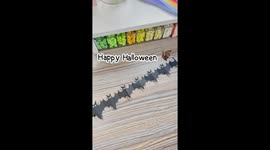 Turn black art paper into DIY origami Halloween bat garland