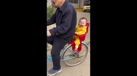 Great-grandfather takes baby girl for ride on bike