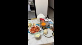 Pet cat steals shrimps from dining table in China