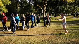 People take a last look at what looks like a sleepwalking man in his pants. It is one of the works at this year's Frieze art sculpture trail in Regents Park