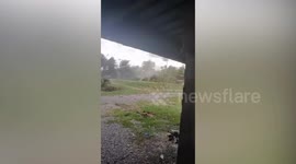 Debris flies through the air as tornado rips through village in Malaysia
