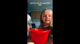 Mommy gets her daughter with the egg prank while making brownies