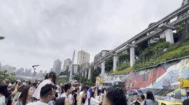 Chongqing, china: spectacular trains passing through building tunnel