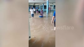 Teacher ferries schoolgirl on basin as heavy flood swamps school in Thailand