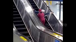 Subway employee dashes to save elderly man from escalator fall in China