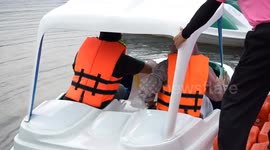 Tourists enjoy free boat rides at idyllic lake in Bangkok, Thailand
