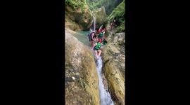 Girl gets stuck while sliding down natural rock waterfall