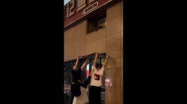 Heroic Chinese men use plastic board to save kitten trapped on building's ledge