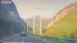 Two boulders crash down mountainside narrowly missing car