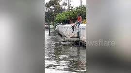 Locals use motorboat to save dog stranded in canal