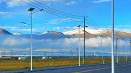 Spectacular snow-covered mountain surrounded by low clouds in China