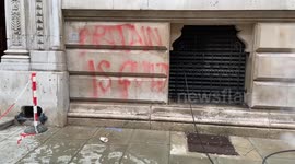 Workers steam-clean pro-Palestine graffiti and red paint outside the Foreign Office