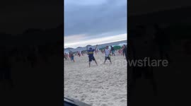 Brazilian police use force as Fluminense fans ambush Boca fans on a Rio beach