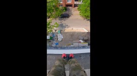 Thrill-seeker's INSANE 13-metre jump off building into pile of sand in Essen, Germany
