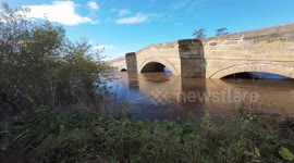 Deep floodwater surging through Newsham Bridge near Malton