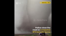 Police closes road as a massive tornado forms