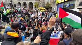 Pro-Palestine protesters sit and block Piccadilly Circus