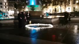 During the Million Mask March protest in another part of Trafalgar Square a couple got engaged. Nick proposed to Sheetal and got a responding yes as protestors police and passers by clapped