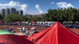 Show-off runner backflips over finish line at university relay race