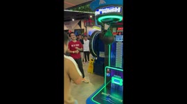 Show off swings at boxing machine but misses punchbag