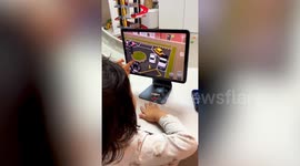 Toddler effortlessly parks car on driving simulation videogame