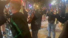 Celtic fans sing along with local Spanish Guitarist as thing heat up the night before the big match in Madrid.