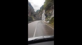 Heavy Rain Creates a Waterfall Over Road
