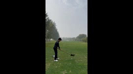 Elegant Absurdity: Golf Enthusiast's Unconventional Swing With Shovel in China