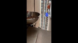 Resident gives lunch to workers abseiling down tower block