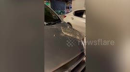 Concrete chunk falls from expressway into parked car